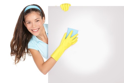 Trained carpet cleaner using professional equipment in a home